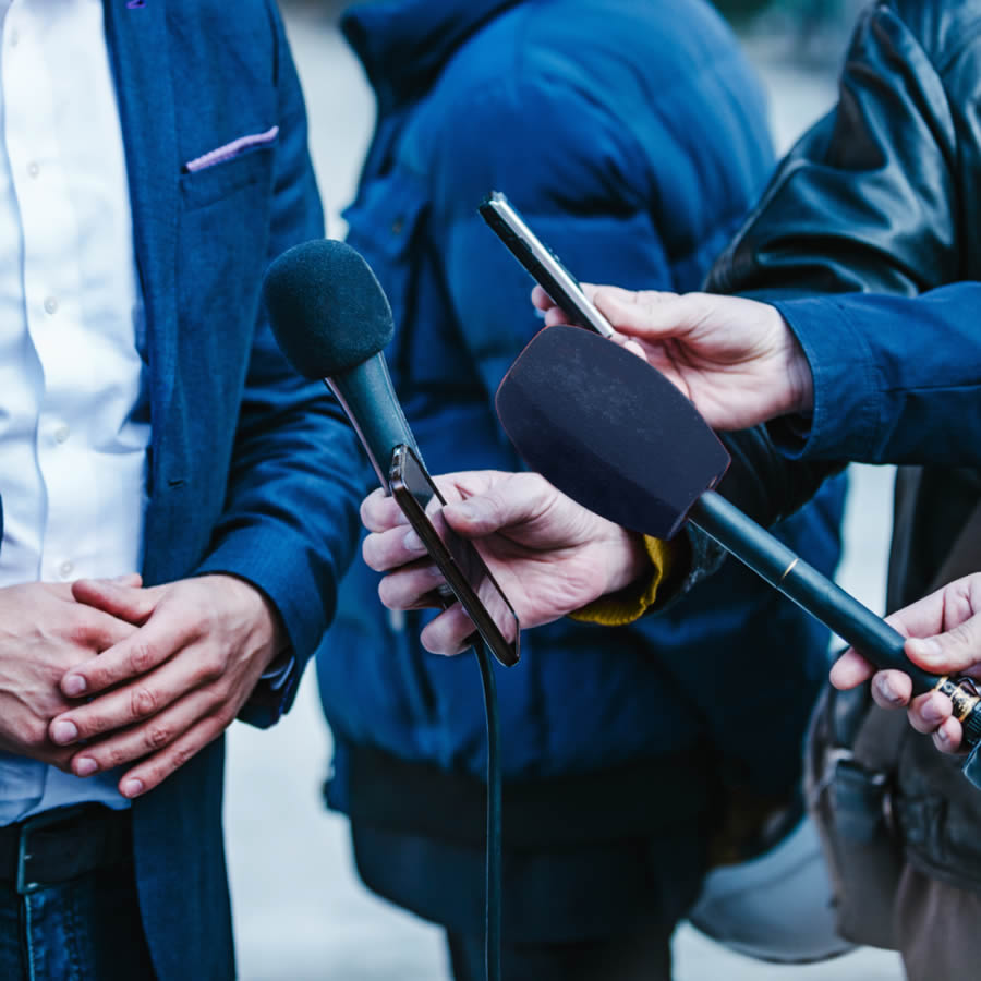 hands-holding-microphones-and-phone